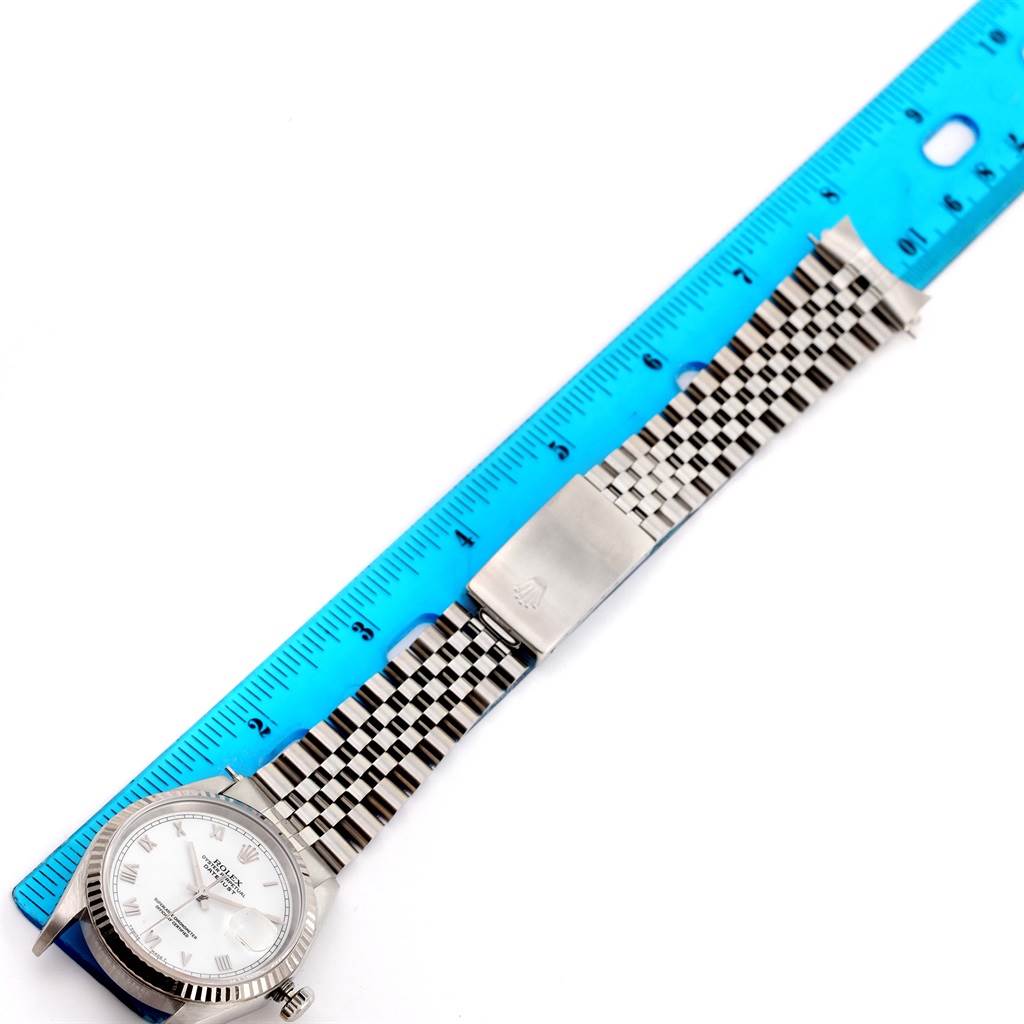 This image shows a Rolex Datejust 16234 Men's Stainless Steel White Dial 16234 Men's Stainless Steel White Dial watch with the face and full bracelet, placed alongside a blue ruler for measurement.
