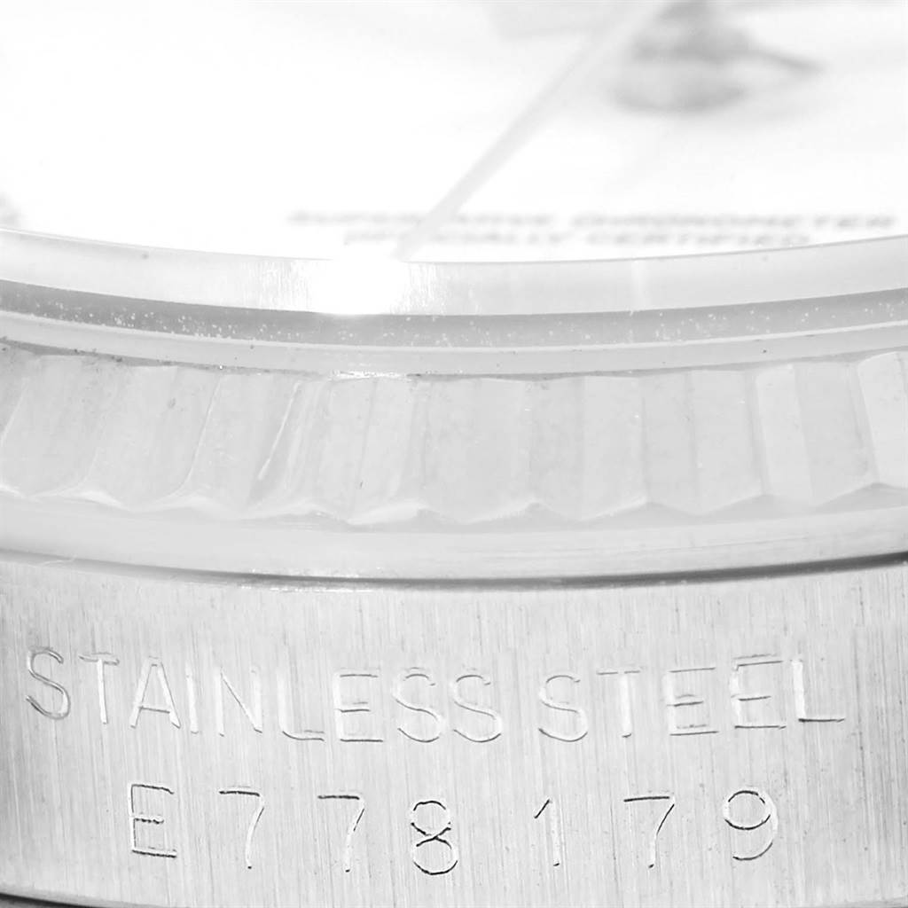 This image shows a close-up side view of the case and part of the bezel and dial of a Rolex Datejust 16234 Men's Stainless Steel White Dial 16234 Men's Stainless Steel White Dial, highlighting the "Stainless Steel" engraving.