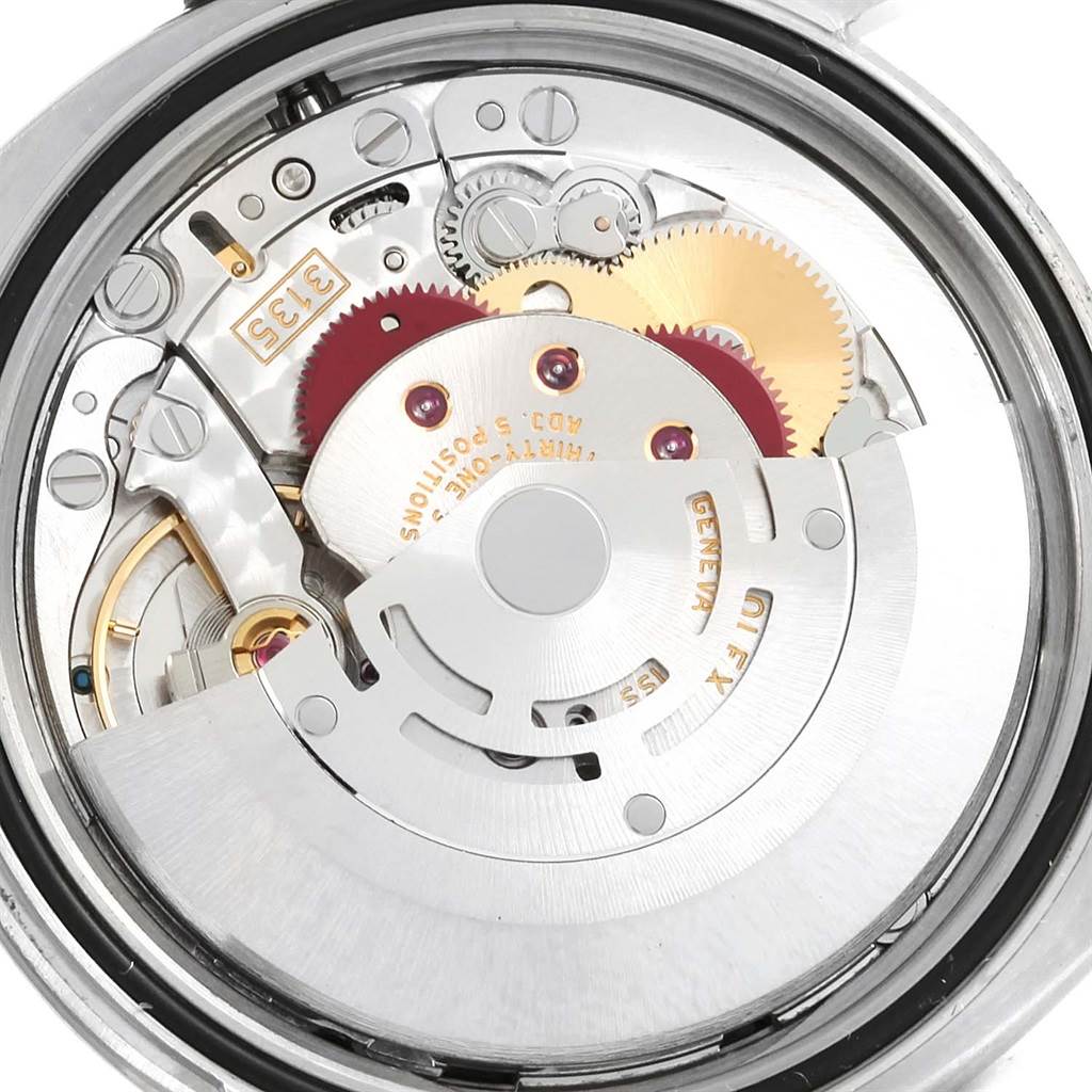 The image shows a close-up of the internal mechanism of a Rolex Datejust 116234 Men
s Stainless Steel Black Dial 116234 Men
s Stainless Steel Black Dial watch, highlighting its gears and rotor.