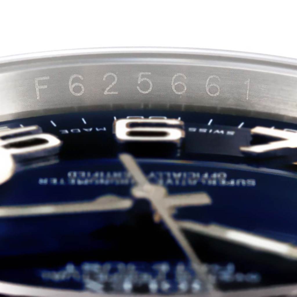 The image shows the Datejust model by Rolex at an angle, highlighting the serial number on the inner bezel.