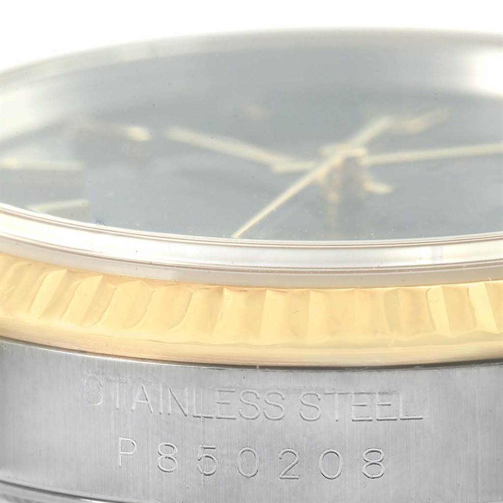 The image shows a close-up, angled view of a Rolex Datejust 16233 Men's Steel and Gold (two tone) Black Dial 16233 Men's Steel and Gold (two tone) Black Dial watch, highlighting the bezel, dial, and stainless steel engraving.