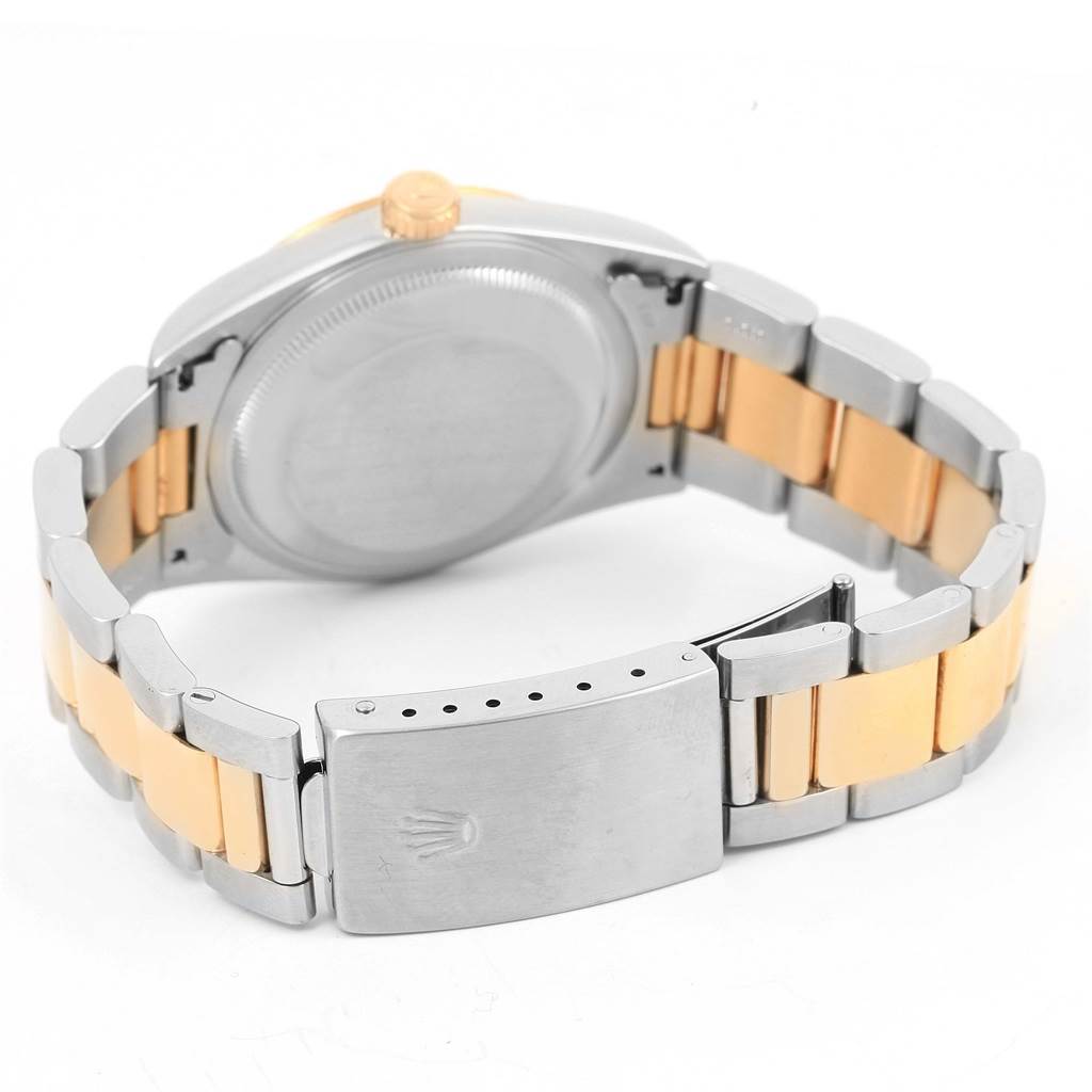 The image shows the back and clasp of a Rolex Datejust 16233 Men's Steel and Gold (two tone) Black Dial 16233 Men's Steel and Gold (two tone) Black Dial watch, highlighting its two-tone metal bracelet.