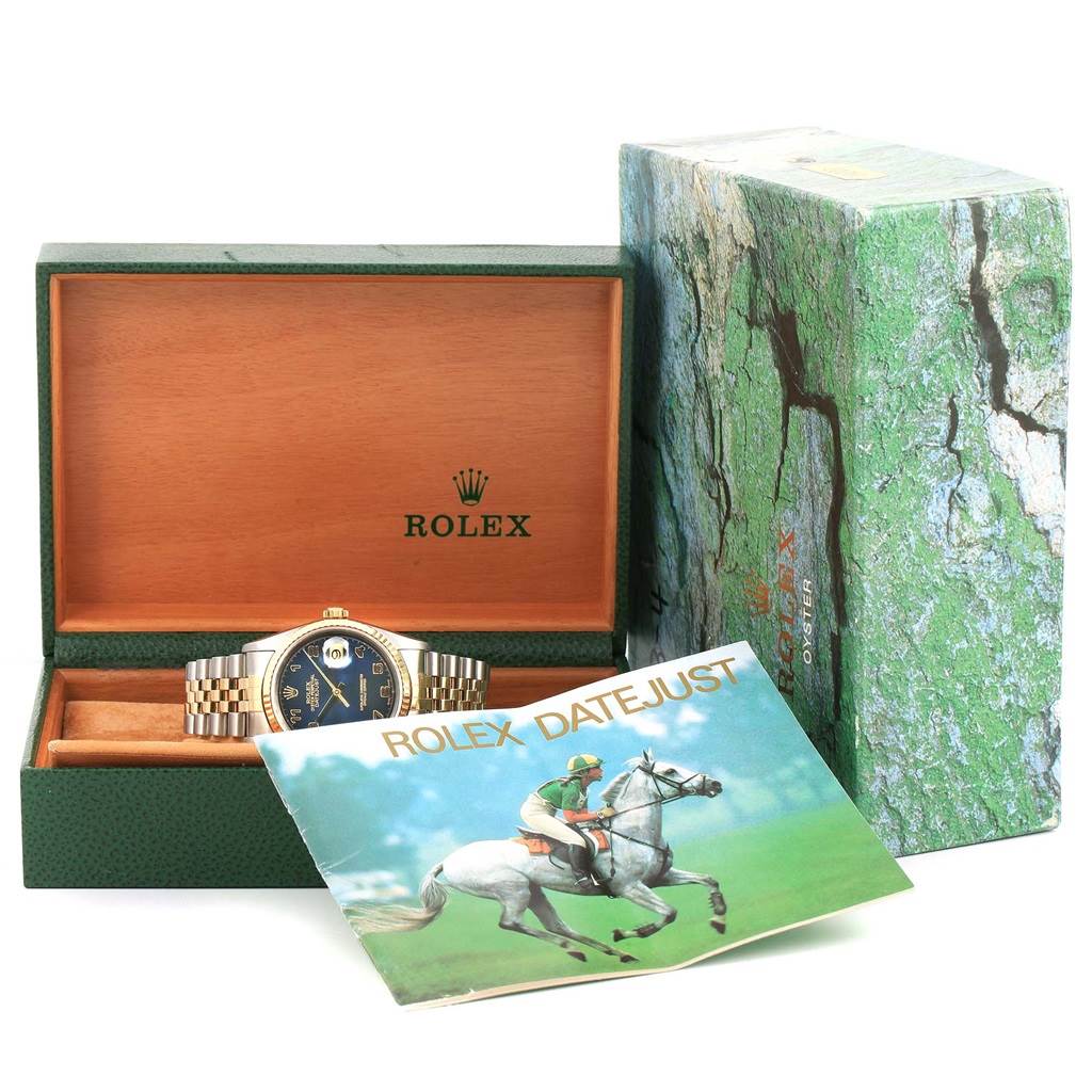 The Rolex Datejust 16233 Men's Steel and Gold (two tone) Blue Dial 16233 Men's Steel and Gold (two tone) Blue Dial watch is displayed in its open box with its booklet and outer packaging shown.