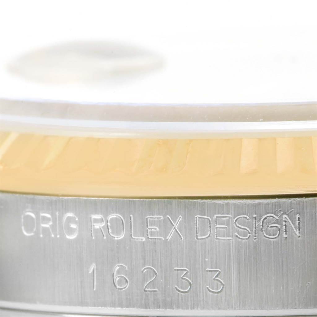 Close-up of the case side of the Rolex Datejust 16233 Men's Steel and Gold (two tone) Champagne Dial 16233 Men's Steel and Gold (two tone) Champagne Dial model with "ORIG ROLEX DESIGN 16233" engraved.