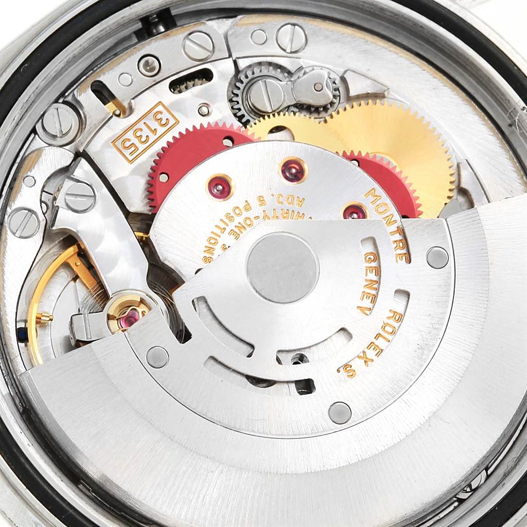 This image shows a close-up view of the movement parts in the Rolex Datejust 16220 Men's Stainless Steel Silver Dial 16220 Men's Stainless Steel Silver Dial watch, including gears and the rotor.