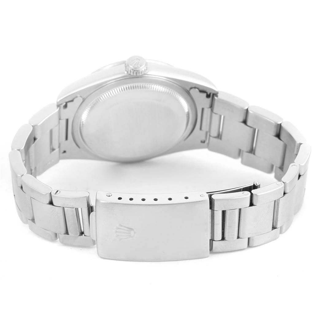 The image shows the back view of a Rolex Datejust 16220 Men's Stainless Steel Silver Dial 16220 Men's Stainless Steel Silver Dial watch, highlighting its clasp, bracelet, and case back.