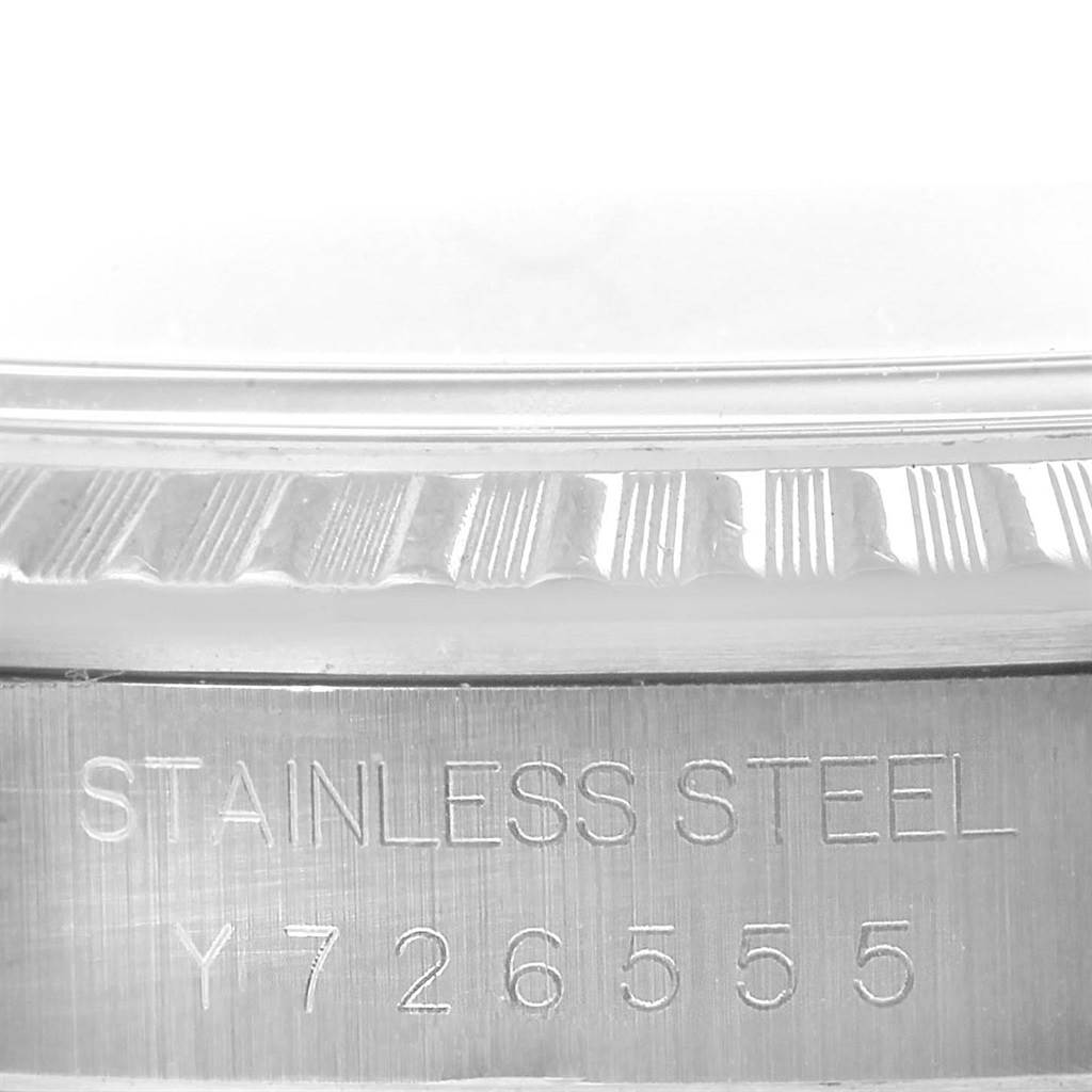 The image shows a close-up of the serial number and fluted bezel on the stainless steel case of a Rolex Datejust 16220 Men's Stainless Steel Silver Dial 16220 Men's Stainless Steel Silver Dial watch.