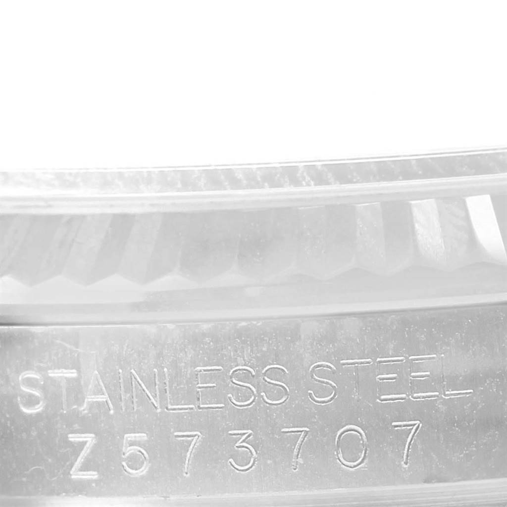 This image shows a close-up of the stainless steel casing and serial number of a Rolex Datejust 116234 Men's Stainless Steel Silver Dial 116234 Men's Stainless Steel Silver Dial watch.