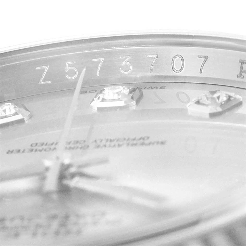 Close-up of the Rolex Datejust 116234 Men's Stainless Steel Silver Dial 116234 Men's Stainless Steel Silver Dial dial, showing diamond markers and the engraved serial number on the inner bezel.