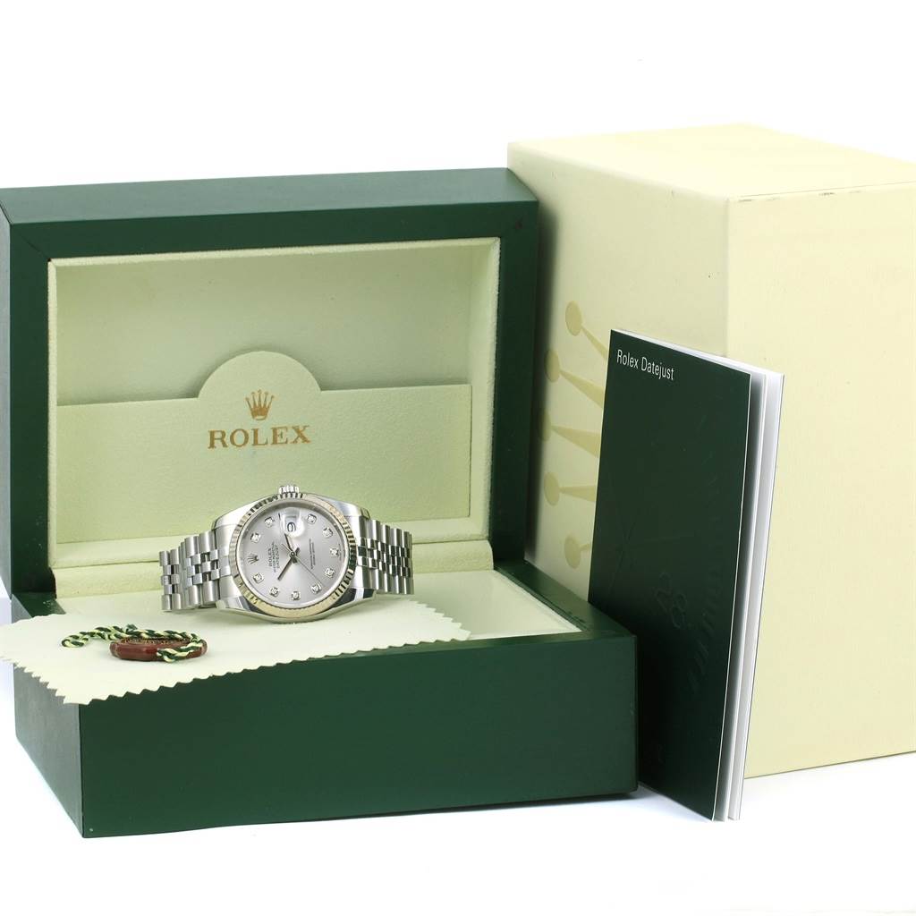 The image shows a Rolex Datejust 116234 Men's Stainless Steel Silver Dial 116234 Men's Stainless Steel Silver Dial watch in an open box, with a booklet and a cleaning cloth on the side.