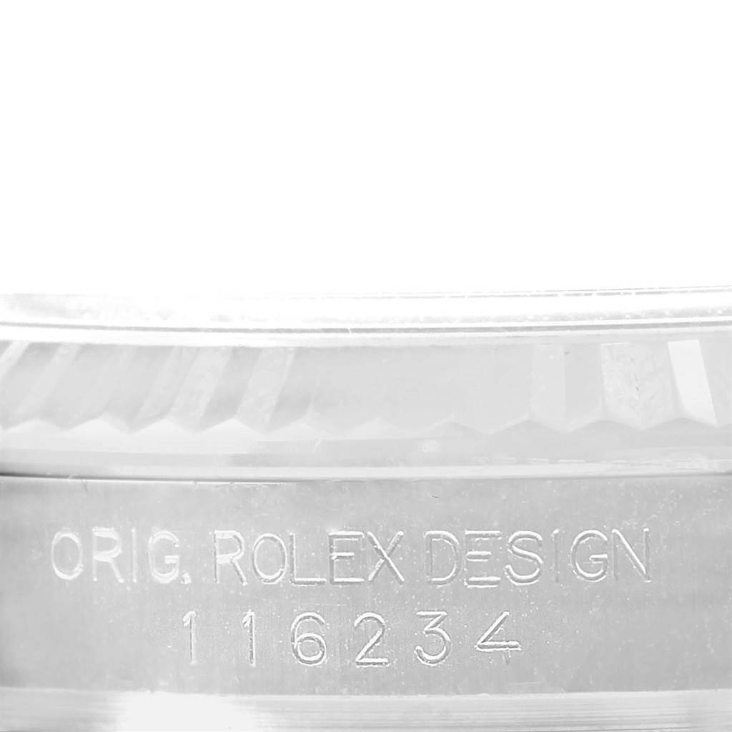 The image shows the detailed engraving on the case side of a Rolex Datejust 116234 Men's Stainless Steel Silver Dial 116234 Men's Stainless Steel Silver Dial watch.
