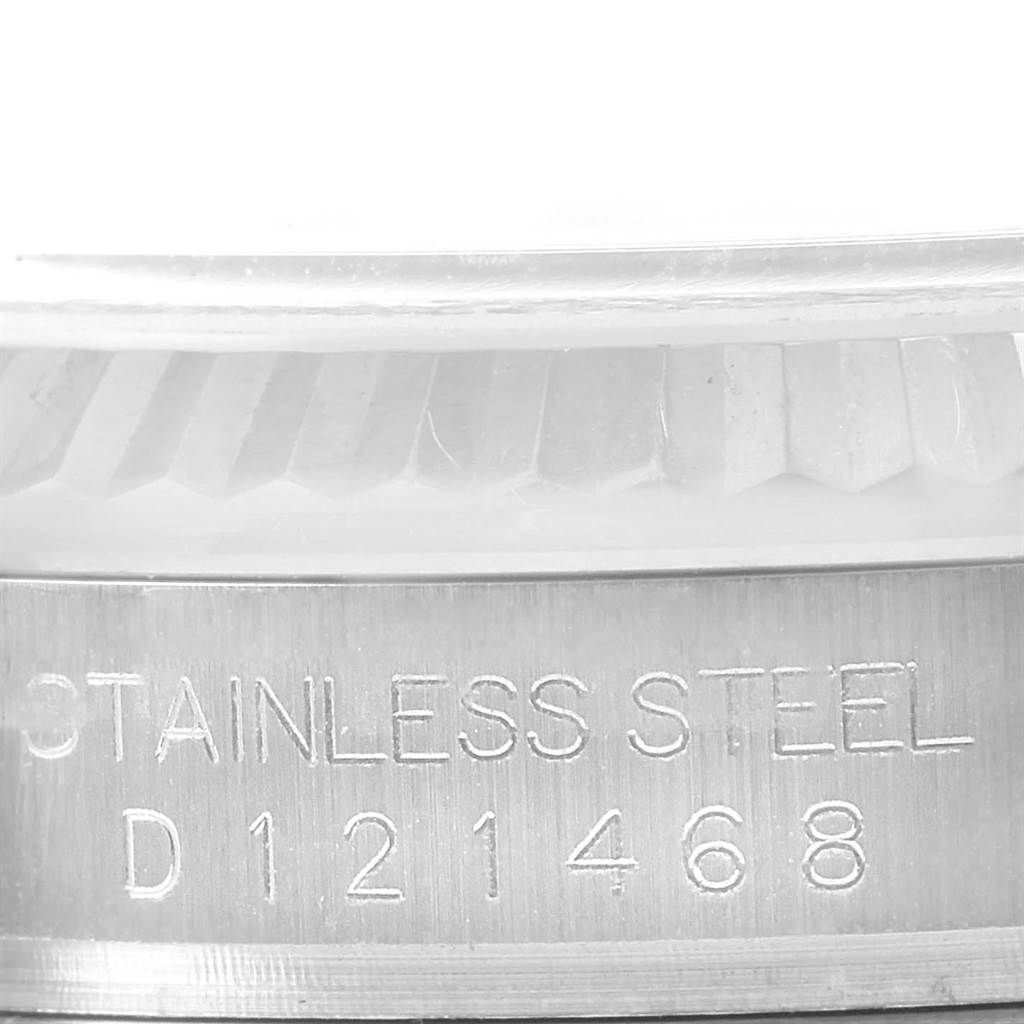 The image shows an angled close-up of the serial number and "STAINLESS STEEL" engraving on the bezel side of a Rolex Datejust 116234 Men's Stainless Steel Blue Dial 116234 Men's Stainless Steel Blue Dial watch.