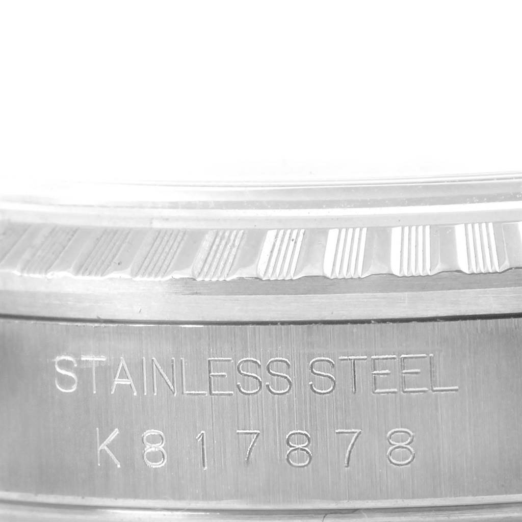 This image shows a close-up of the serial number and "Stainless Steel" engraving on the side of a Rolex Datejust 16220 Men's Stainless Steel Blue Dial 16220 Men's Stainless Steel Blue Dial watch case.