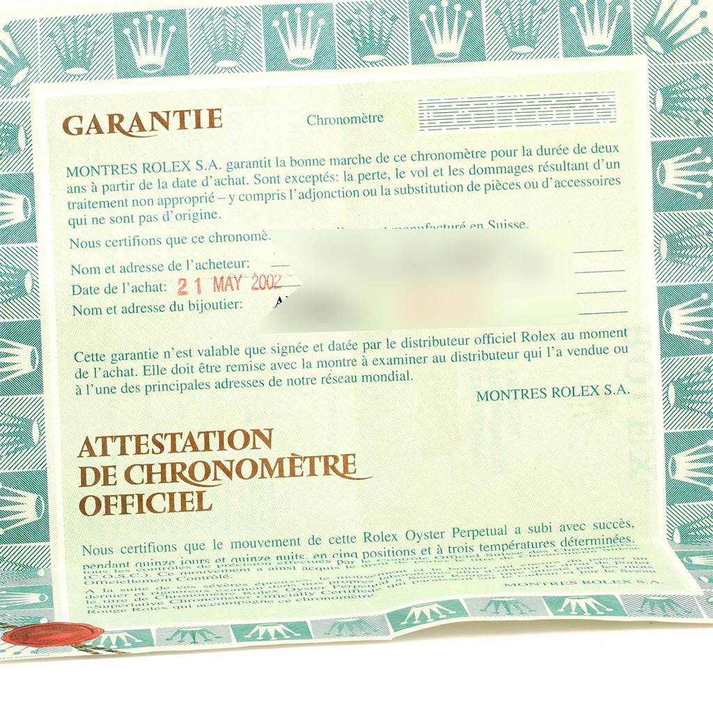 The image shows a warranty certificate for the Rolex Datejust 16220 Men's Stainless Steel Blue Dial 16220 Men's Stainless Steel Blue Dial, dated May 21, 2002, detailing purchase information and guarantee terms.