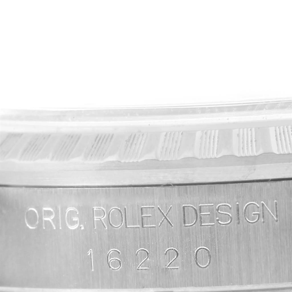 This close-up image shows the engraved text on the case side of a Rolex Datejust 16220 Men's Stainless Steel Blue Dial 16220 Men's Stainless Steel Blue Dial watch, including the model number.