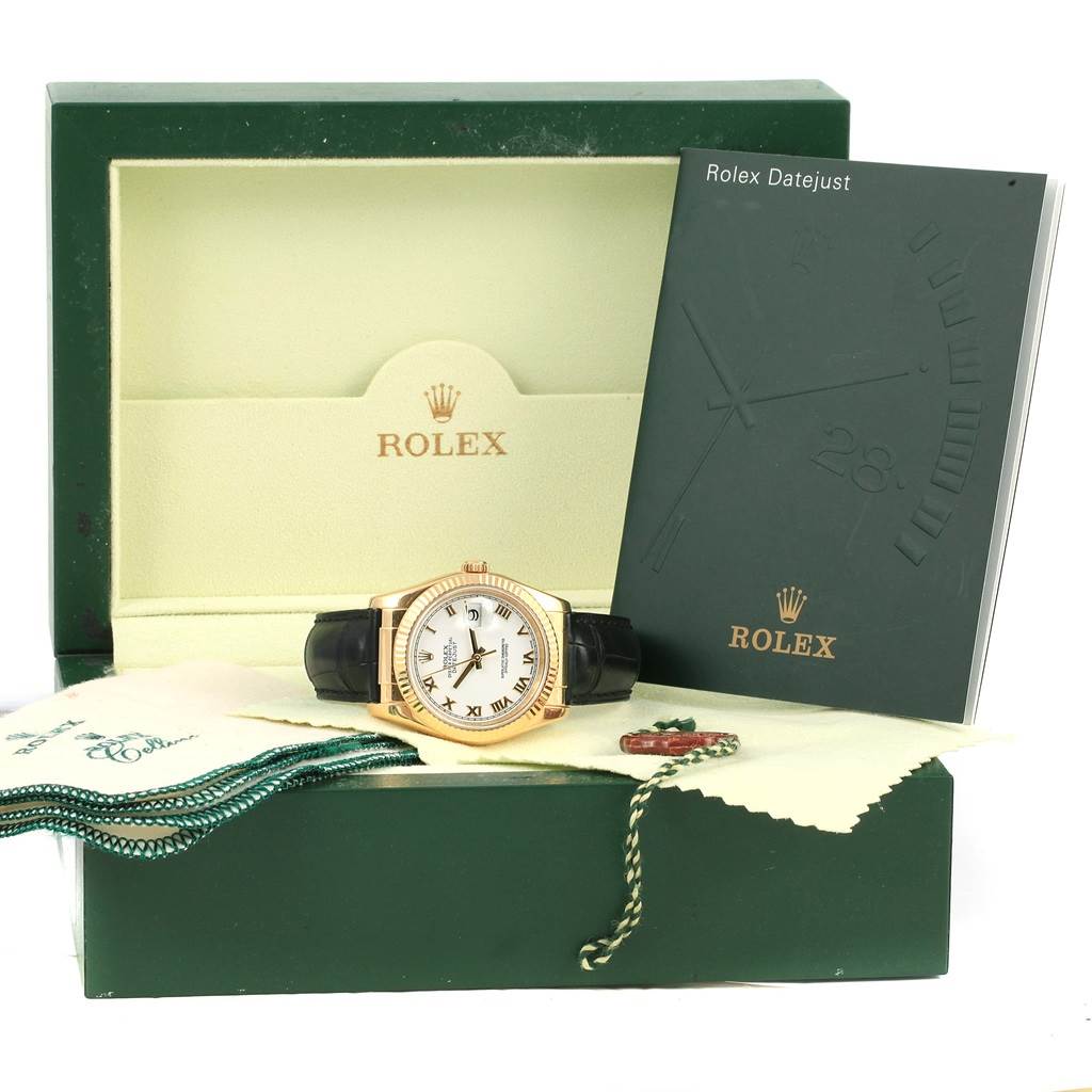 The image shows a Rolex Datejust 116138 Men's Yellow Gold White Dial 116138 Men's Yellow Gold White Dial watch and its box, set on a table, along with a booklet and polishing cloth.