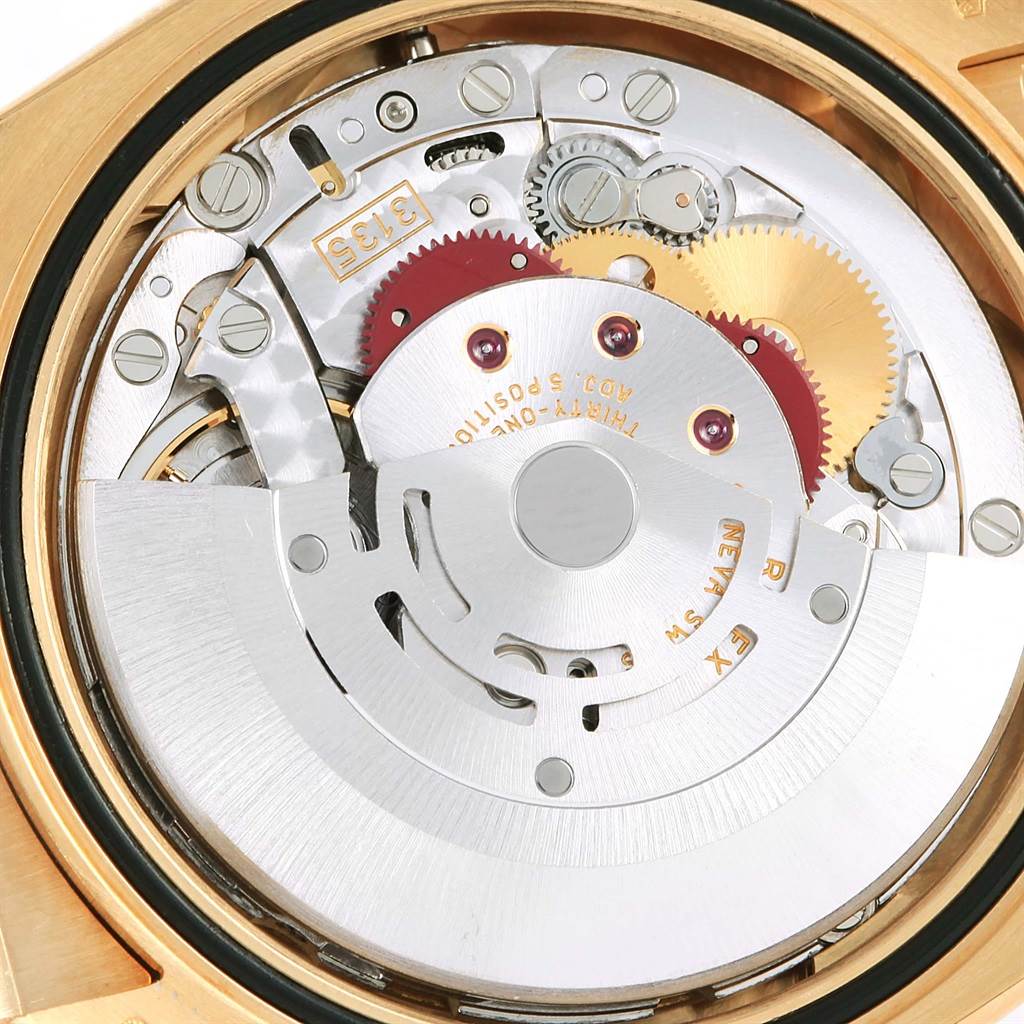 The image displays a close-up view of the movement parts inside a Rolex Datejust 116138 Men's Yellow Gold White Dial 116138 Men's Yellow Gold White Dial watch, revealing gears and intricate mechanisms.