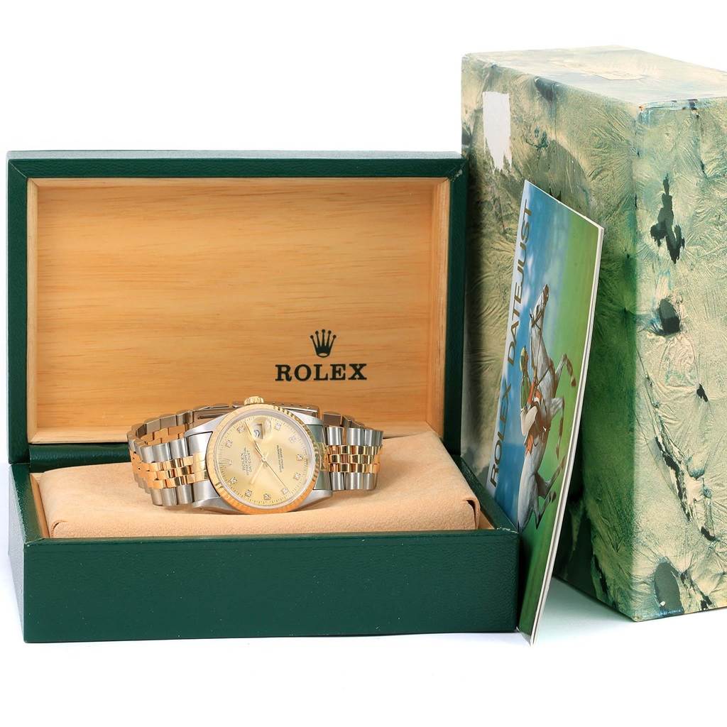 The image shows a Rolex Datejust 16233 Men
s Steel and Gold (two tone) Champagne Dial 16233 Men
s Steel and Gold (two tone) Champagne Dial watch in its open box, with a partial view of its bracelet and packaging.
