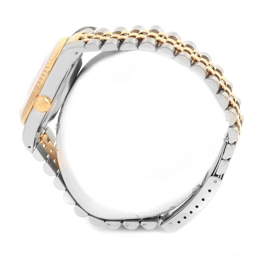 The image shows a side view of the Rolex Datejust 16233 Men
s Steel and Gold (two tone) Champagne Dial 16233 Men
s Steel and Gold (two tone) Champagne Dial watch, highlighting the crown, bezel, and two-tone bracelet.