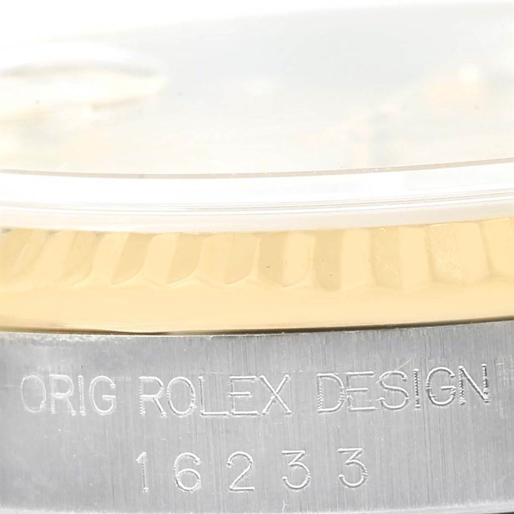 The image shows a close-up of the side of a Rolex Datejust 16233 Men
s Steel and Gold (two tone) Champagne Dial 16233 Men
s Steel and Gold (two tone) Champagne Dial watch, highlighting the model number and bezel.