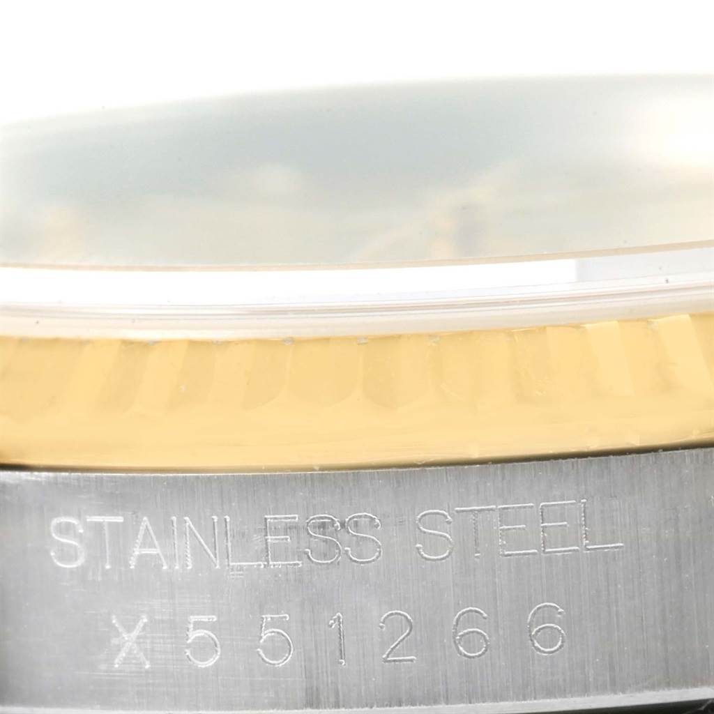 Close-up of a Rolex Datejust 16233 Men
s Steel and Gold (two tone) Champagne Dial 16233 Men
s Steel and Gold (two tone) Champagne Dial watch, showing the stainless steel case, gold fluted bezel, and engraved serial number.