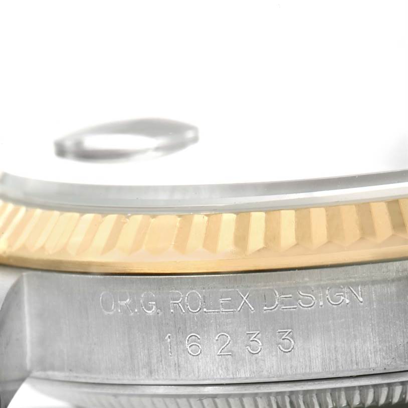 This image shows a close-up side view of the bezel and case of a Rolex Datejust 16233 Men's Steel and Gold (two tone) Black Dial 16233 Men's Steel and Gold (two tone) Black Dial model.