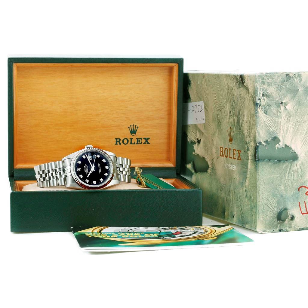 The Rolex Datejust 16234 Men
s Stainless Steel Black Dial 16234 Men
s Stainless Steel Black Dial watch is displayed in its open box alongside packaging and accompanying documents.