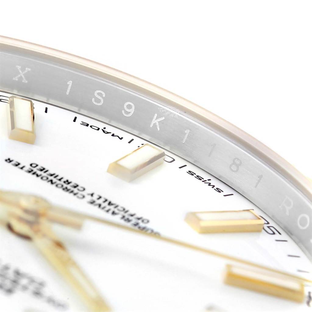 This close-up image of the Rolex Datejust 126333 Men's Steel and Gold (two tone) White Dial 126333 Men's Steel and Gold (two tone) White Dial watch showcases the dial, indices, and part of the rehaut with engraved serial numbers.