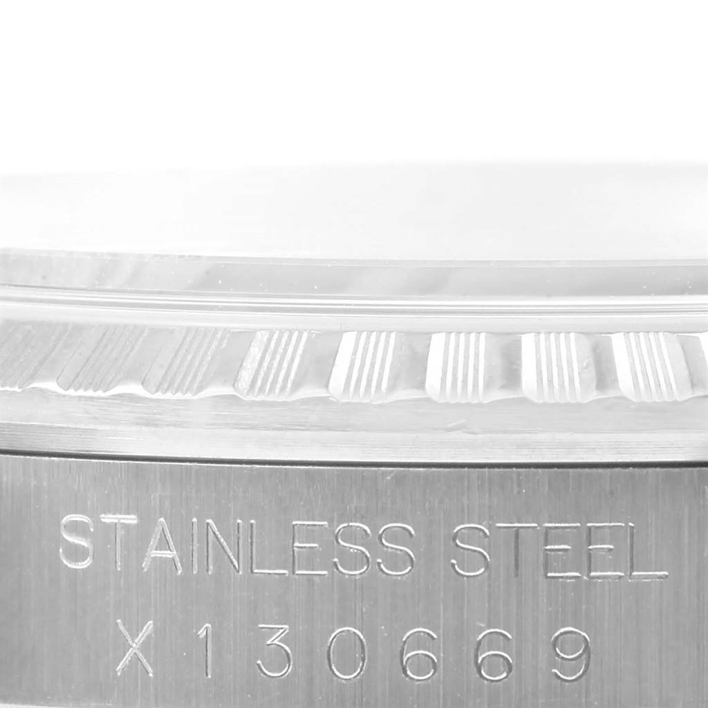 The image shows a close-up of the stainless steel side and fluted bezel of a Rolex Datejust 16220 Men
s Stainless Steel Silver Dial 16220 Men
s Stainless Steel Silver Dial watch.