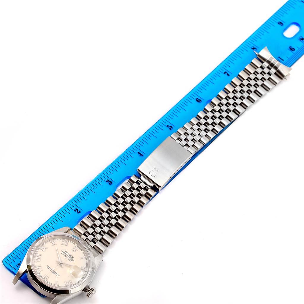 The image shows the Rolex Datejust 16200 Men's Stainless Steel Beige Dial 16200 Men's Stainless Steel Beige Dial watch face and full bracelet laid flat against a blue ruler.