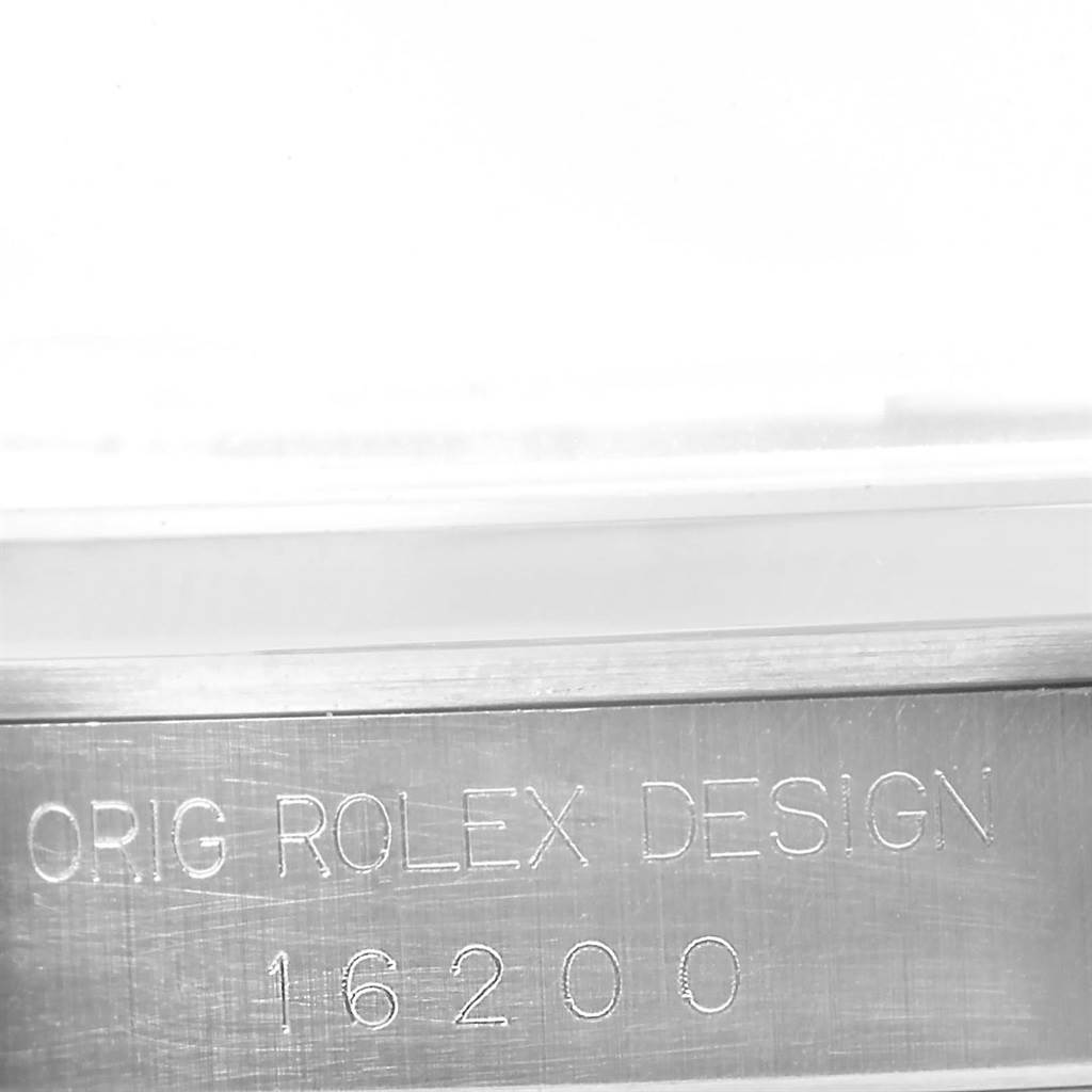 The image shows a close-up of the case side of a Rolex Datejust 16200 Men's Stainless Steel Beige Dial 16200 Men's Stainless Steel Beige Dial, displaying the engraving "ORIG ROLEX DESIGN 16200."