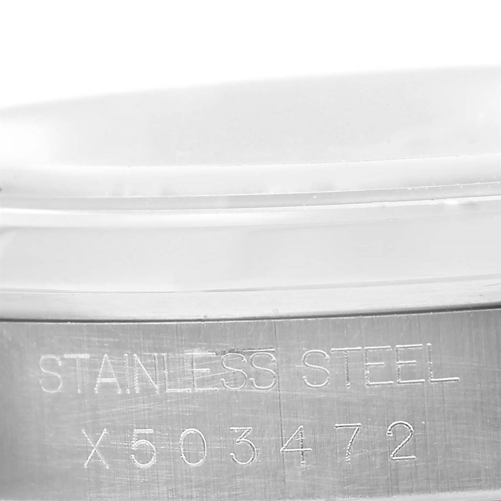 This image shows a close-up of the serial number and "STAINLESS STEEL" engraving on a Rolex Datejust 16200 Men's Stainless Steel Beige Dial 16200 Men's Stainless Steel Beige Dial watch.