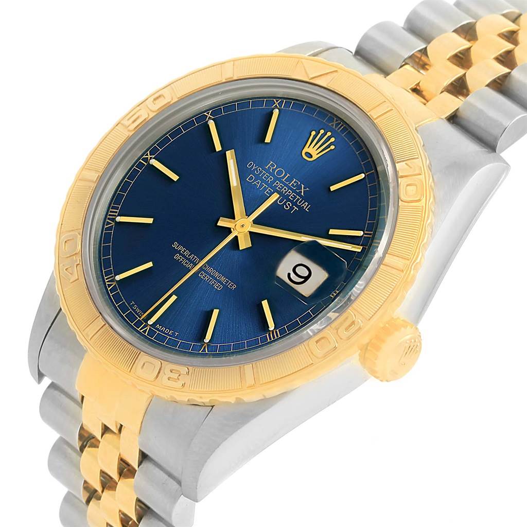 This image shows a Rolex Datejust 16263 Men's Steel and Gold (two tone) Blue Dial 16263 Men's Steel and Gold (two tone) Blue Dial watch from a slight side angle, highlighting its blue dial, gold bezel, and two-tone bracelet.