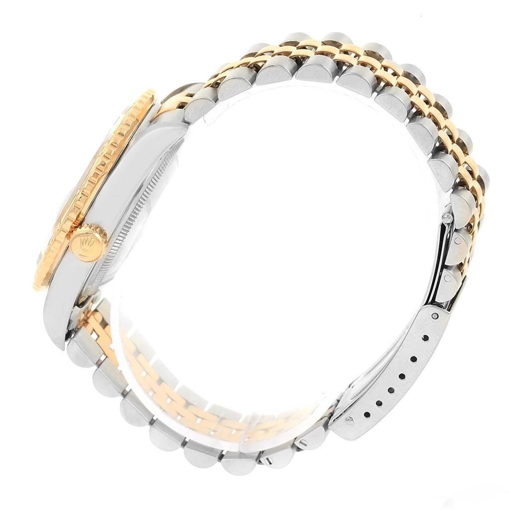 The image shows a side view of the Rolex Datejust 16263 Men's Steel and Gold (two tone) Blue Dial 16263 Men's Steel and Gold (two tone) Blue Dial watch, highlighting its crown, case, and two-tone bracelet.