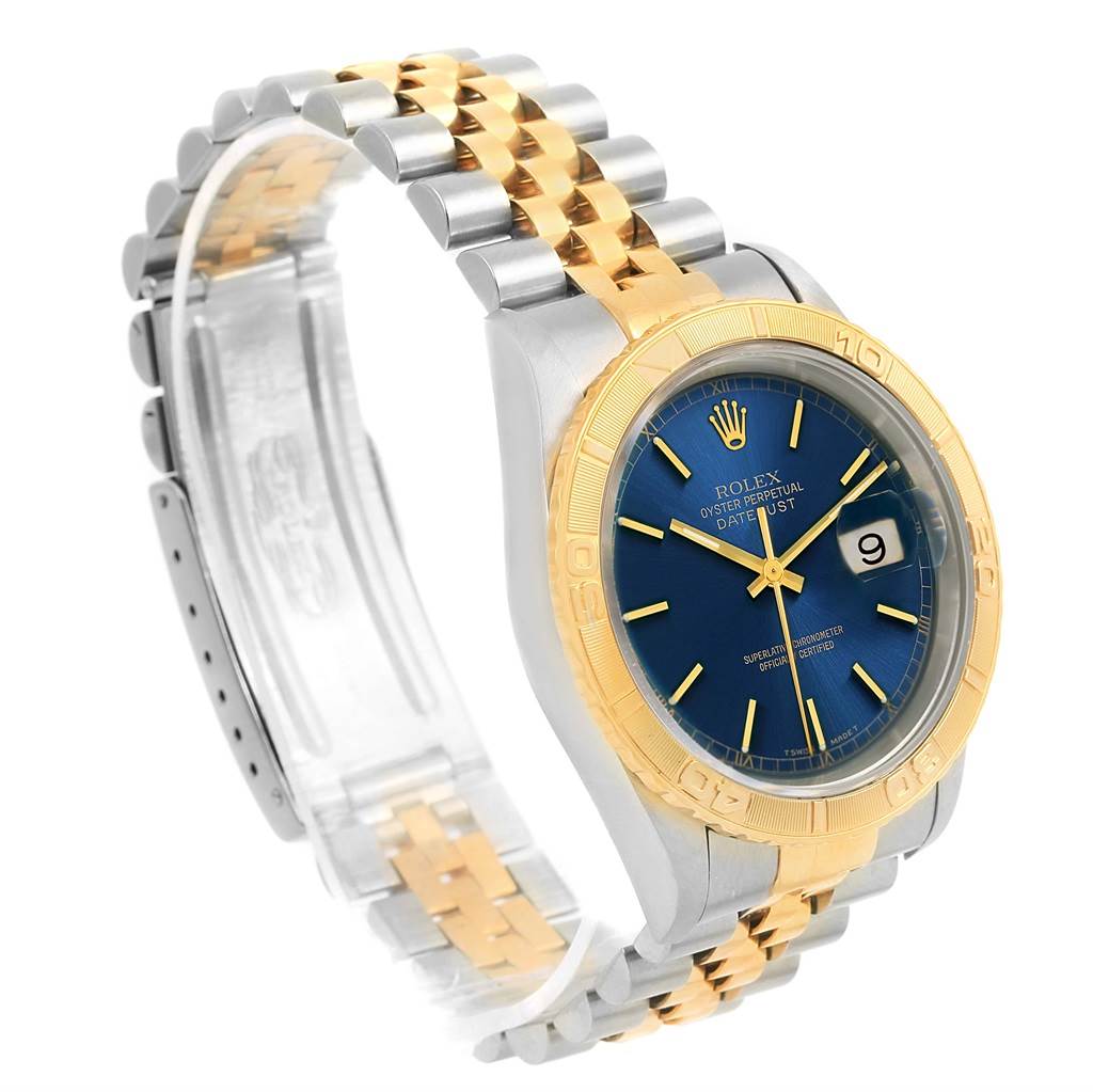 This image shows a side angle of the Rolex Datejust 16263 Men's Steel and Gold (two tone) Blue Dial 16263 Men's Steel and Gold (two tone) Blue Dial watch, highlighting its blue dial, gold bezel, and two-tone metal bracelet.