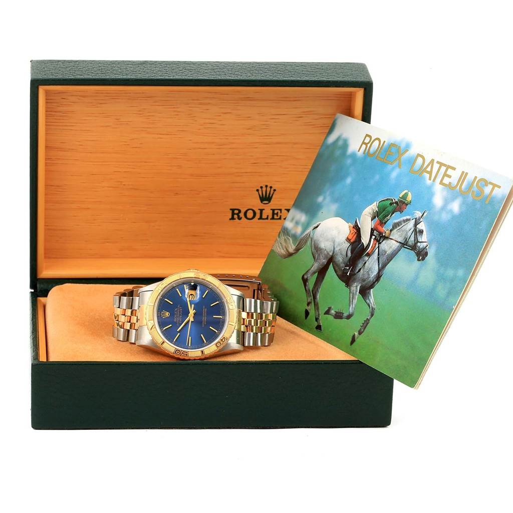 The image shows a Rolex Datejust 16263 Men's Steel and Gold (two tone) Blue Dial 16263 Men's Steel and Gold (two tone) Blue Dial watch in its open box with a booklet to the side.