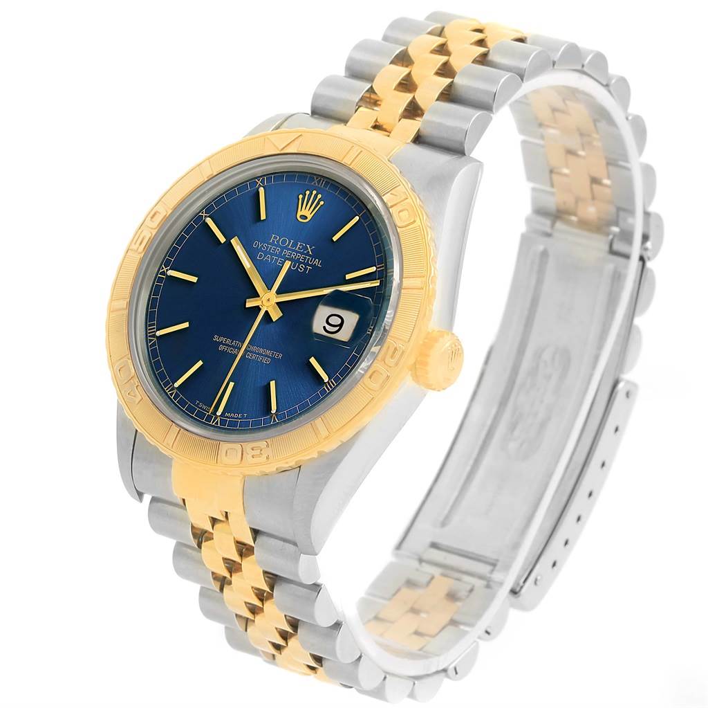The Rolex Datejust 16263 Men's Steel and Gold (two tone) Blue Dial 16263 Men's Steel and Gold (two tone) Blue Dial watch is shown at an angled side view, displaying its blue dial, gold bezel, and two-tone metal bracelet.