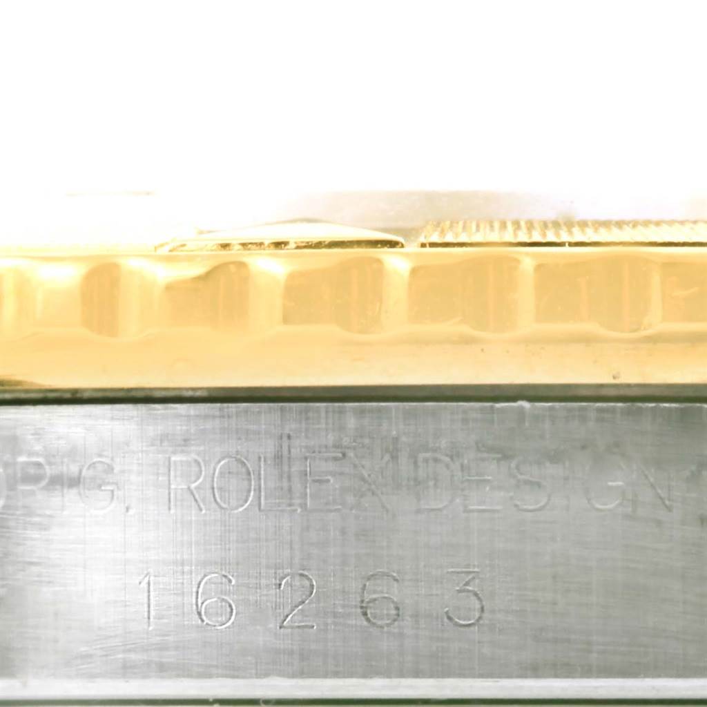 This image shows the side view of a Rolex Datejust 16263 Men's Steel and Gold (two tone) Blue Dial 16263 Men's Steel and Gold (two tone) Blue Dial watch, specifically highlighting part of the bezel and the engraved case.