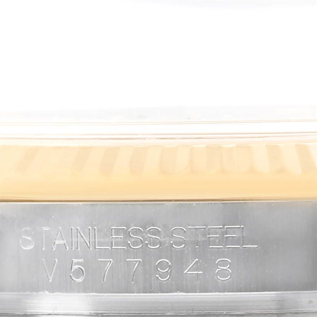 This image shows the side of a Rolex Datejust 116233 Men
s Stainless Steel Champagne Dial 116233 Men
s Stainless Steel Champagne Dial watch displaying its stainless steel inscription and serial number.