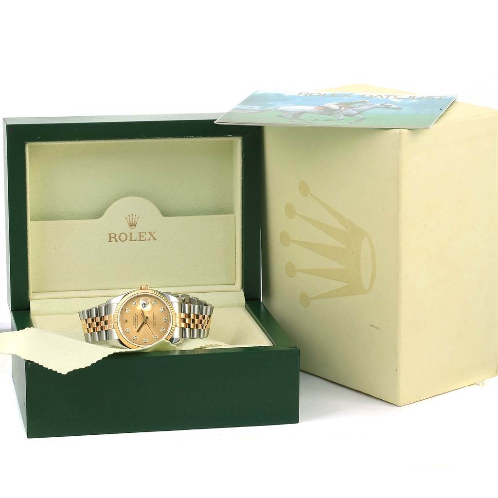 The Rolex Datejust 116233 Men
s Stainless Steel Champagne Dial 116233 Men
s Stainless Steel Champagne Dial watch is shown in its open green box with a two-tone metal band and gold dial, alongside its outer packaging and booklet.