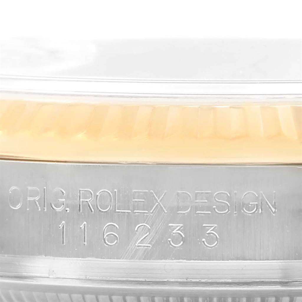This close-up image of the Rolex Datejust 116233 Men
s Stainless Steel Champagne Dial 116233 Men
s Stainless Steel Champagne Dial shows the side of the case with engraving and part of the bezel.