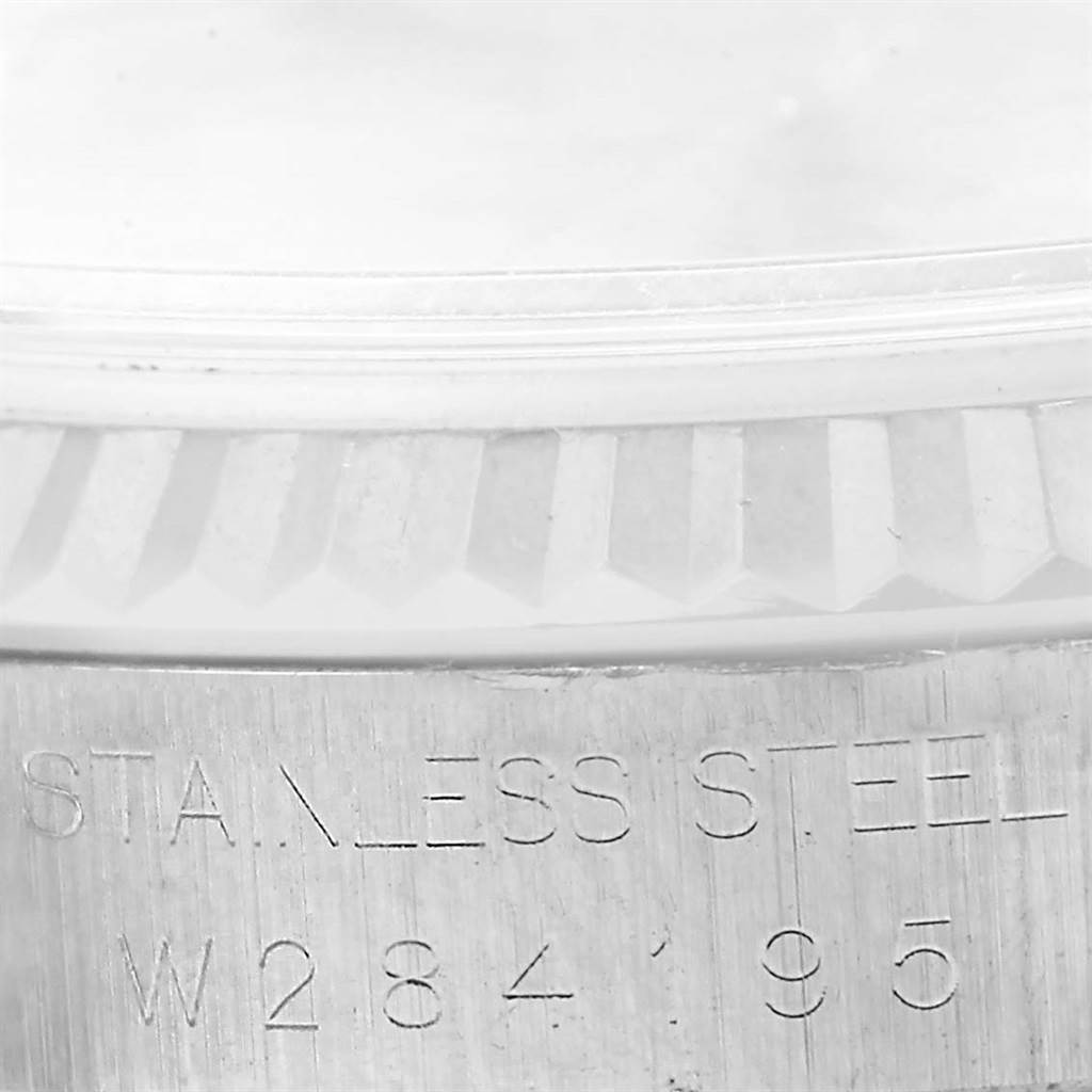 The image shows a close-up of the case back and bezel of a Rolex Datejust 16234 Men
s Stainless Steel Silver Dial 16234 Men
s Stainless Steel Silver Dial watch, highlighting the engraving and part of the fluted bezel.