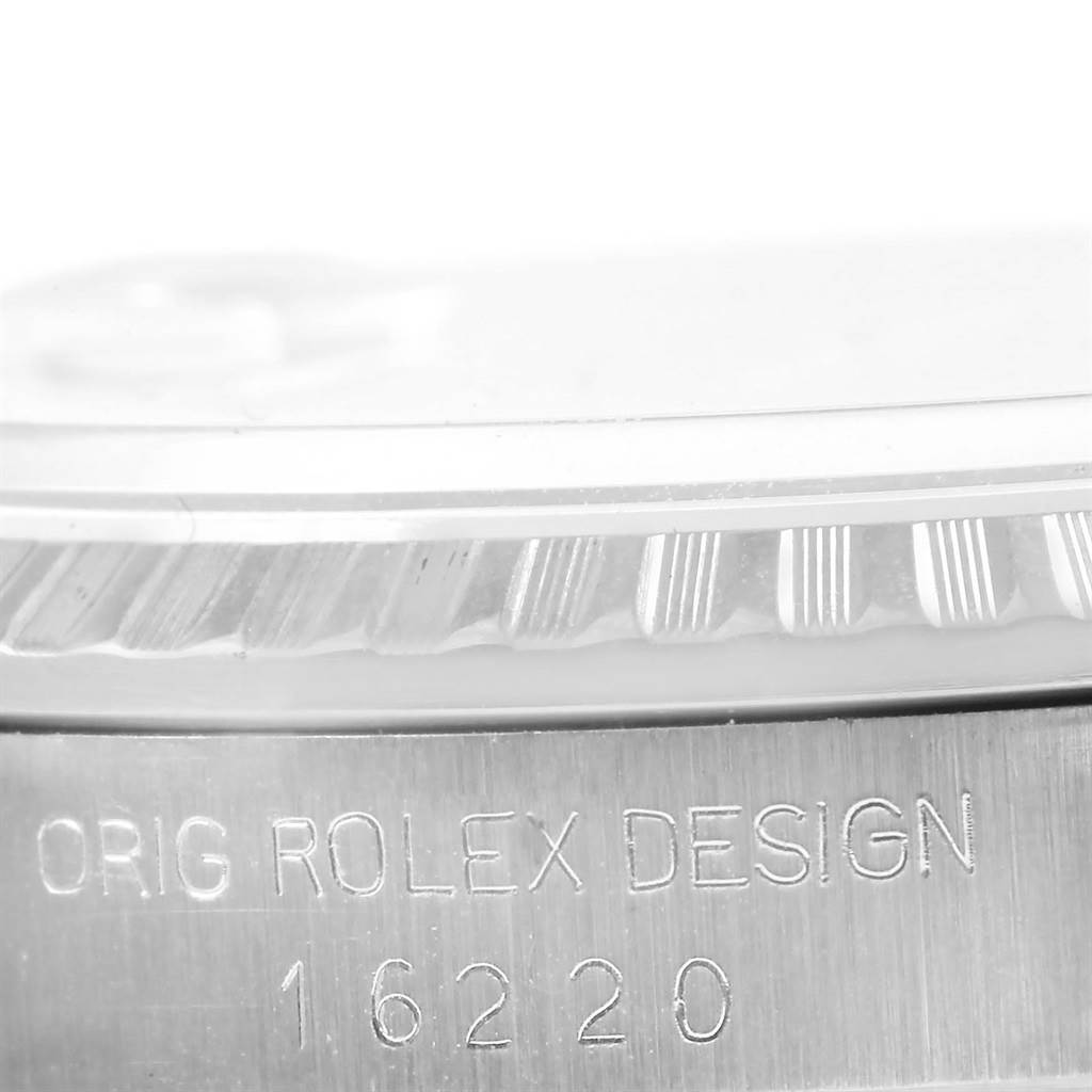 This close-up angle shows the bezel and part of the case of a Rolex Datejust 16220 Men
s Stainless Steel Silver Dial 16220 Men
s Stainless Steel Silver Dial model with its model number engraved.