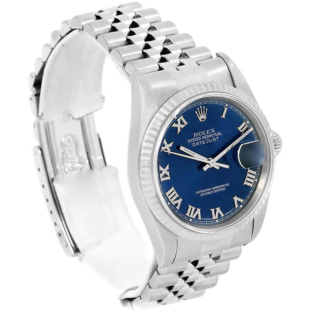 This Rolex Datejust 16234 Men's Stainless Steel Blue Dial 16234 Men's Stainless Steel Blue Dial watch is shown at an angle highlighting its blue dial, Roman numerals, and Jubilee bracelet.