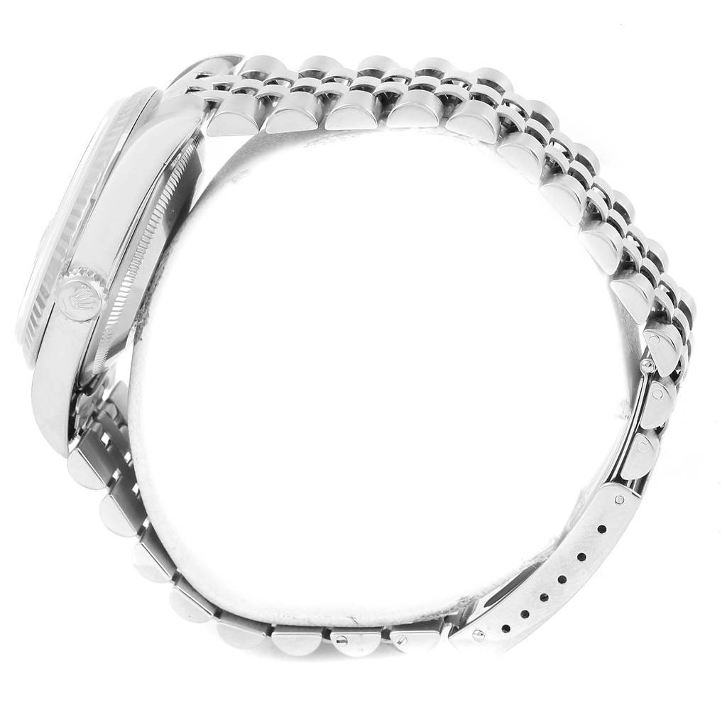 This side view of the Rolex Datejust 16234 Men's Stainless Steel Blue Dial 16234 Men's Stainless Steel Blue Dial watch shows the case, bezel, crown, and linked bracelet.