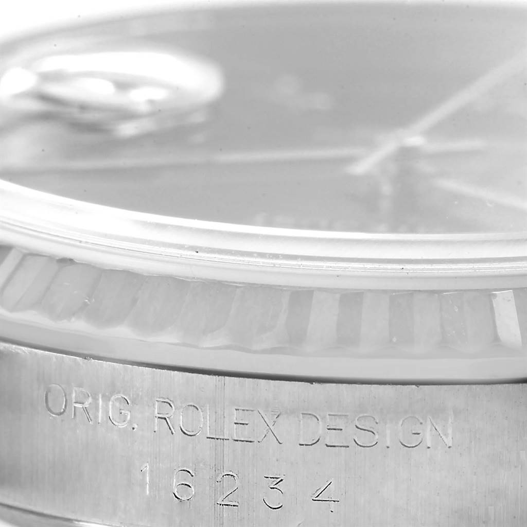 This close-up shows the side profile of the Rolex Datejust 16234 Men's Stainless Steel Blue Dial 16234 Men's Stainless Steel Blue Dial model, highlighting the bezel and engraved text on the case.