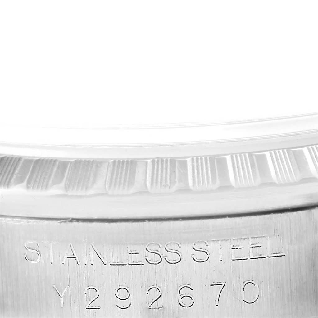 The image shows a close-up of the case of a Rolex Datejust 16220 Men
s Stainless Steel White Dial 16220 Men
s Stainless Steel White Dial watch, highlighting the stainless steel material and the serial number.