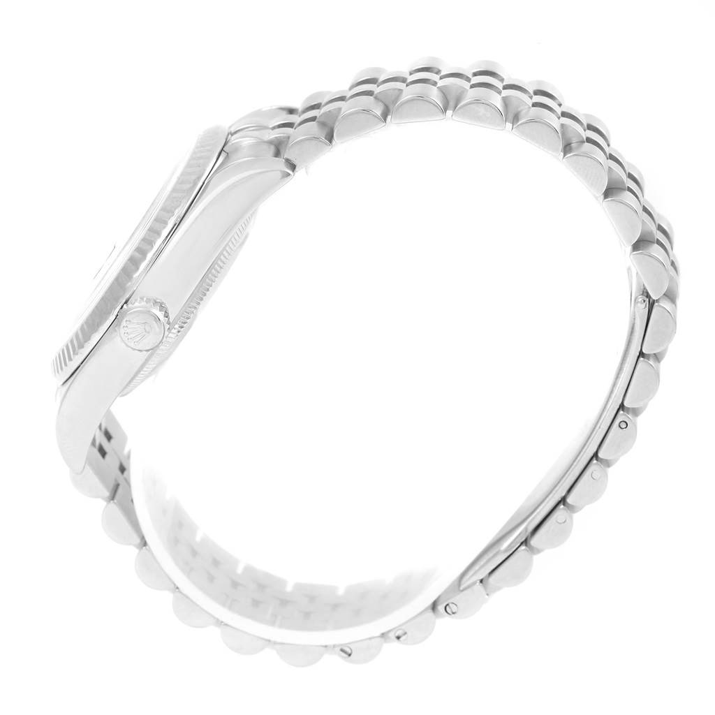 This side view of the Rolex Datejust 116234 Men's Stainless Steel Blue Dial 116234 Men's Stainless Steel Blue Dial watch shows the crown, case, and bracelet prominently.