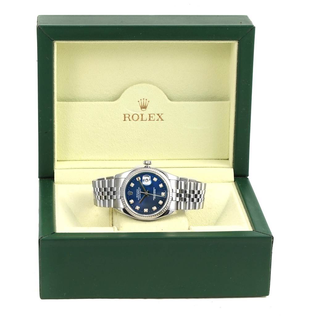 The Rolex Datejust 116234 Men's Stainless Steel Blue Dial 116234 Men's Stainless Steel Blue Dial watch is shown from the front, displayed in an open green box with a blue dial and silver bracelet.
