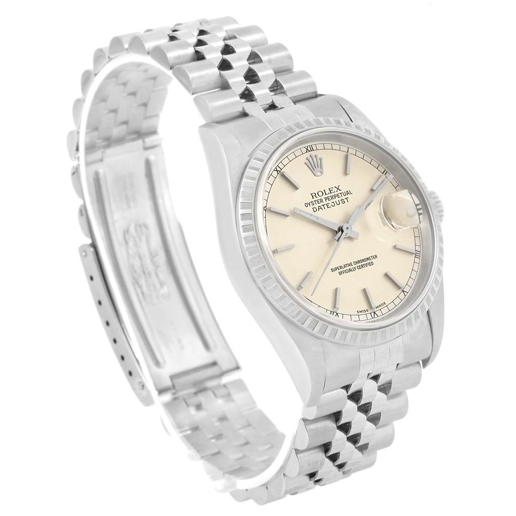 The Rolex Datejust 16220 Men
s Stainless Steel Silver Dial 16220 Men
s Stainless Steel Silver Dial watch is shown at an angled view, highlighting the Jubilee bracelet, fluted bezel, and cream dial.